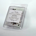 A pale blue packaged soy wax melt in a clear clamshell container with a white label reading 'The Enchanted Chandlery ADORN 100% Soy Wax Handcrafted in Michigan' on a plain white background.